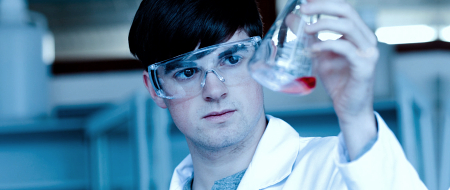 Scientist looking at a beaker